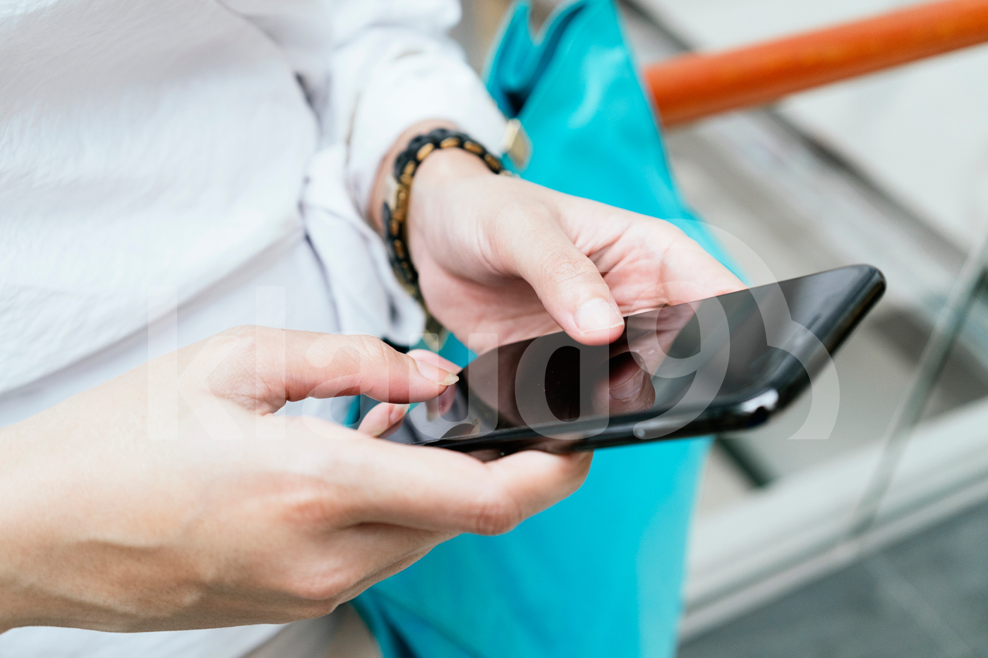 Cropped shot of hands holding smartphone