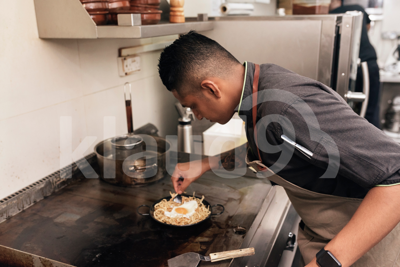 Asian chef preparing food in the restaurant kitchen