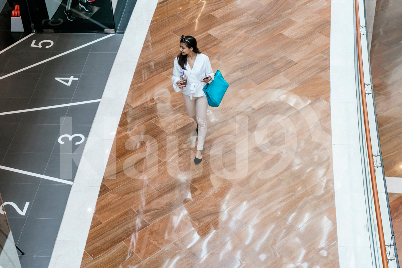 Long shot of woman walking down the mall