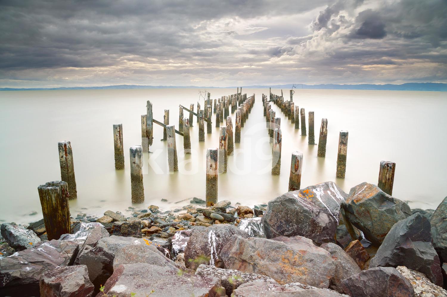 Calm beach under a moody sky ......