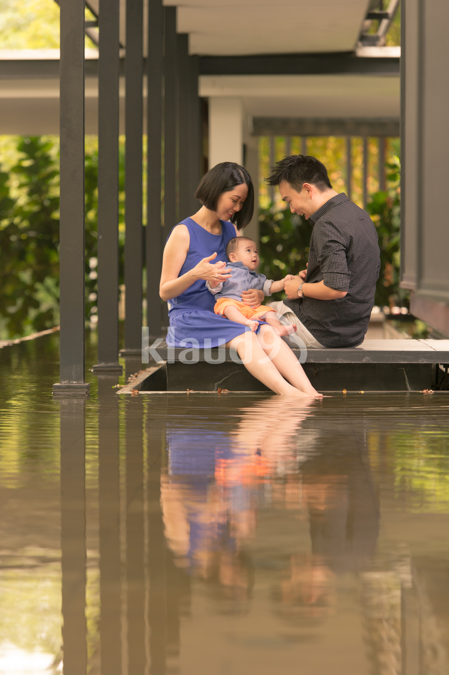Young Chinese family chilling with 5 month old son