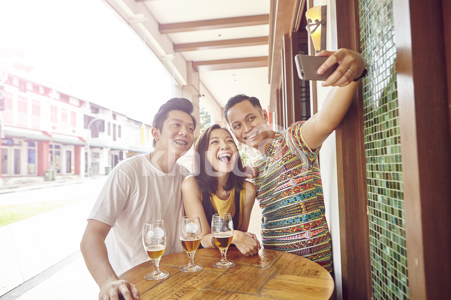 Group of friends taking a selfie at a bar
