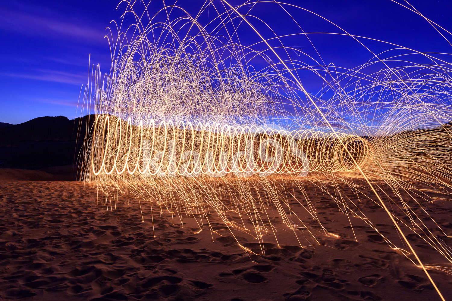 Spiral fire on the beach at twilight,Thailand