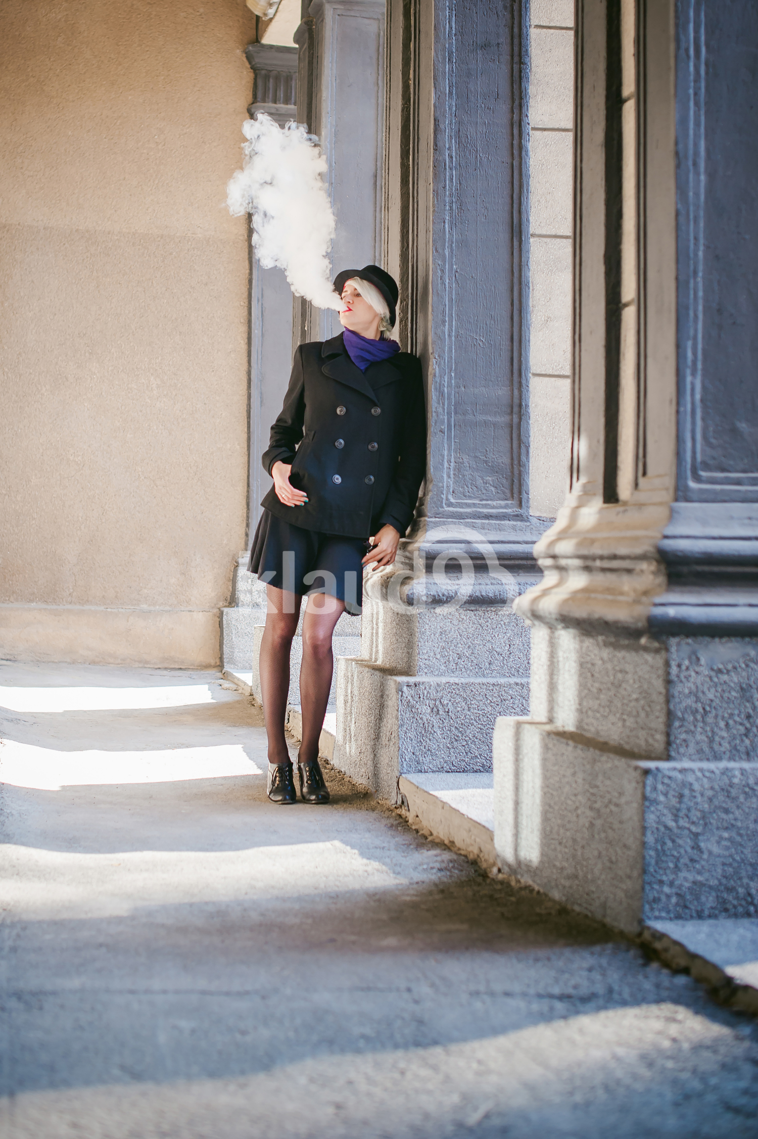 Beautiful young lady vaping on the streets
