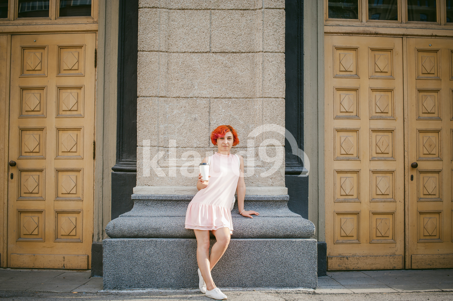 Portrait of a woman on the streets with a coffee cup