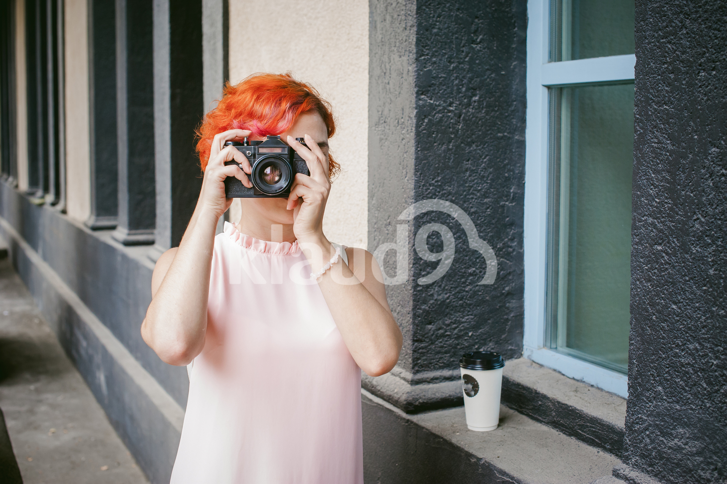 Red head with a film camera