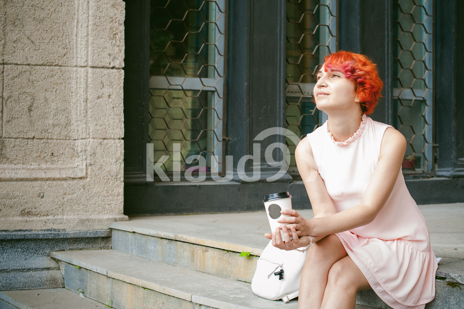 Red haired woman lost in her thoughts