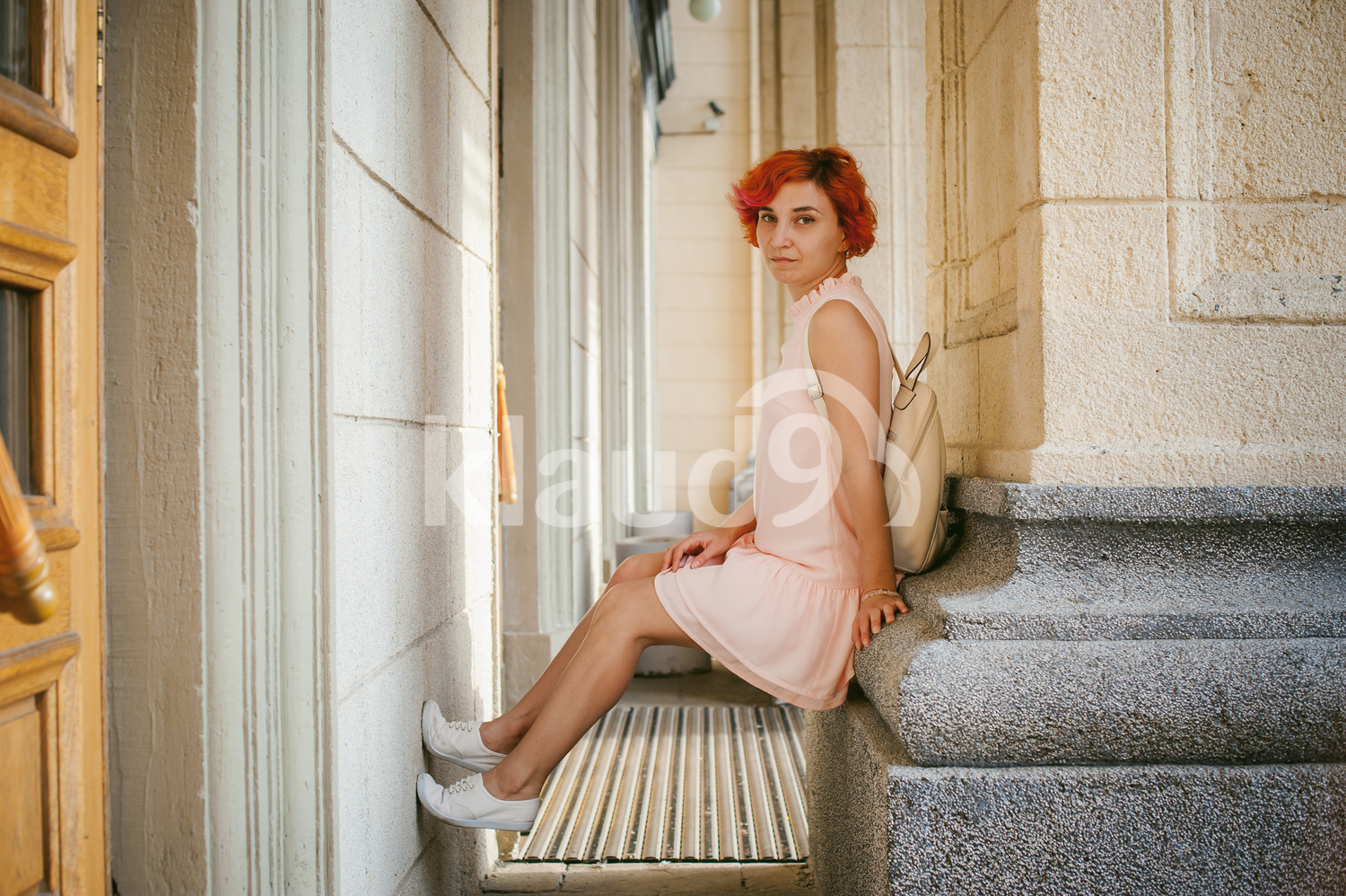Woman resting on a column 