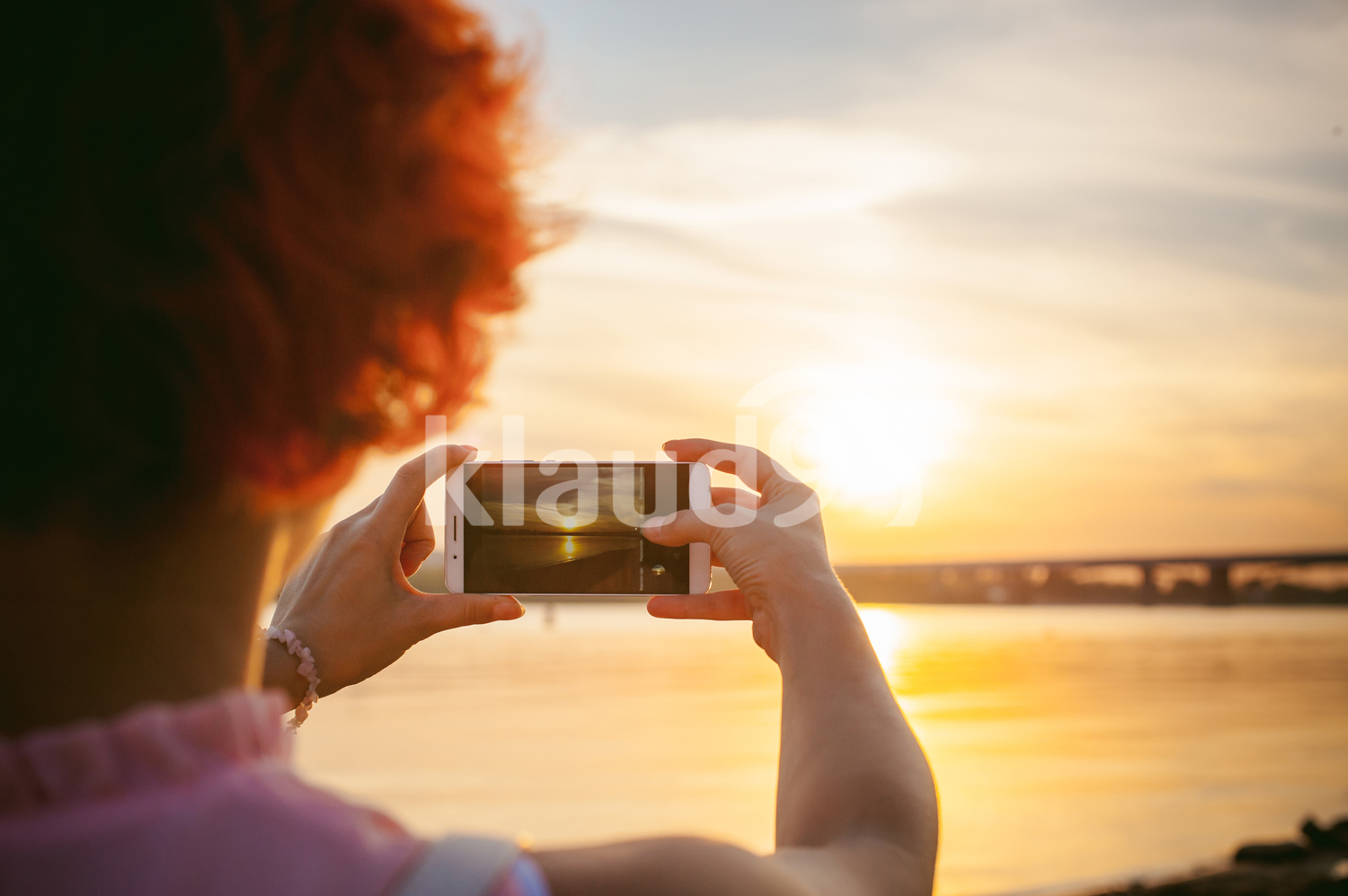 Lady shooting a landscape on a cellphone