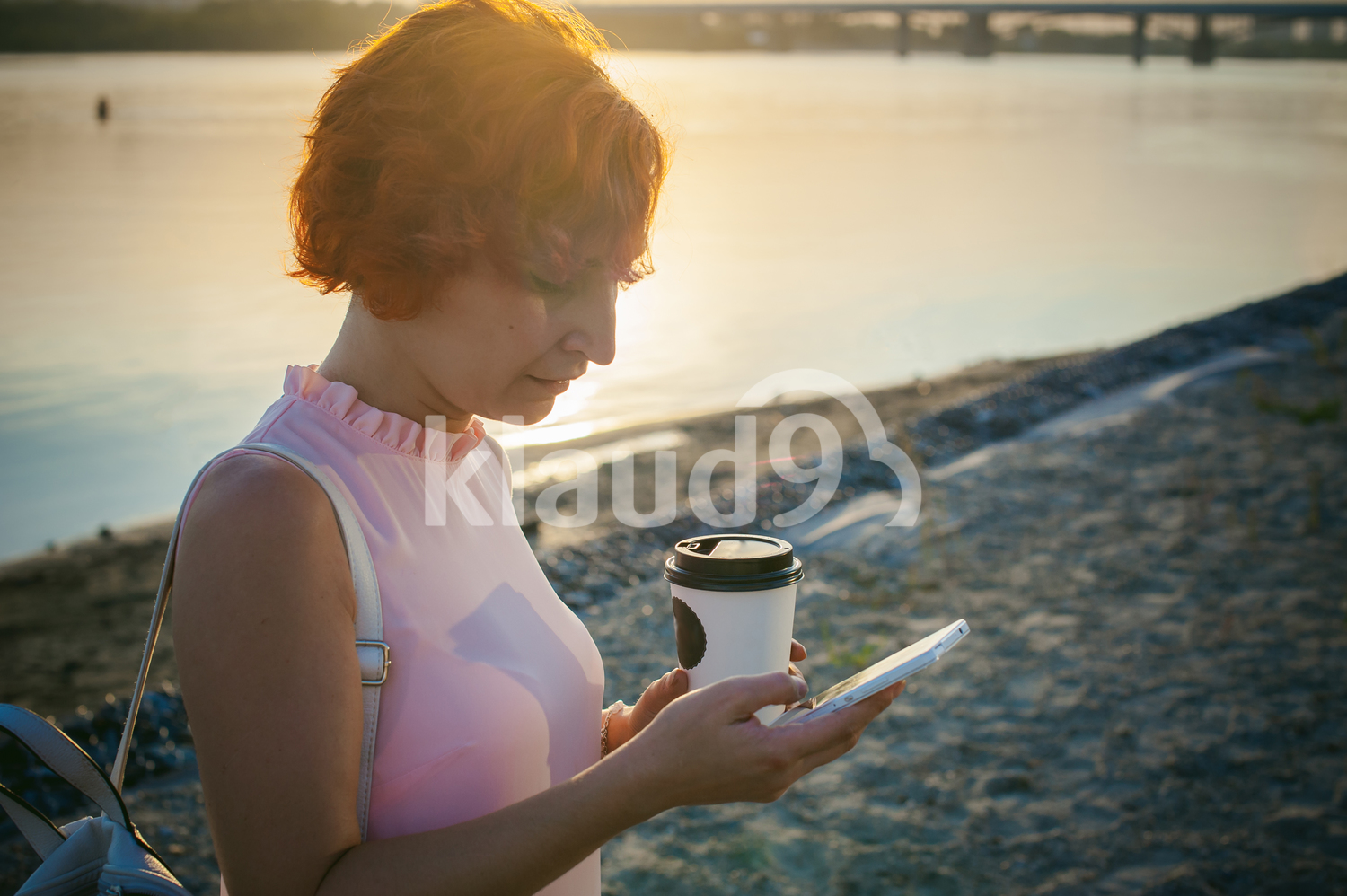 Female with red hair texting on her cell phone