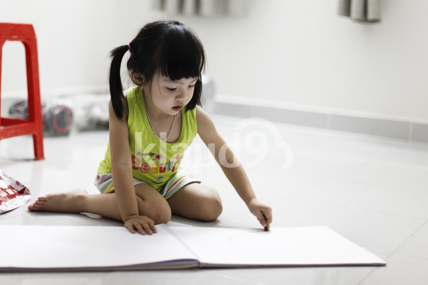 Young girl sketching on her pad