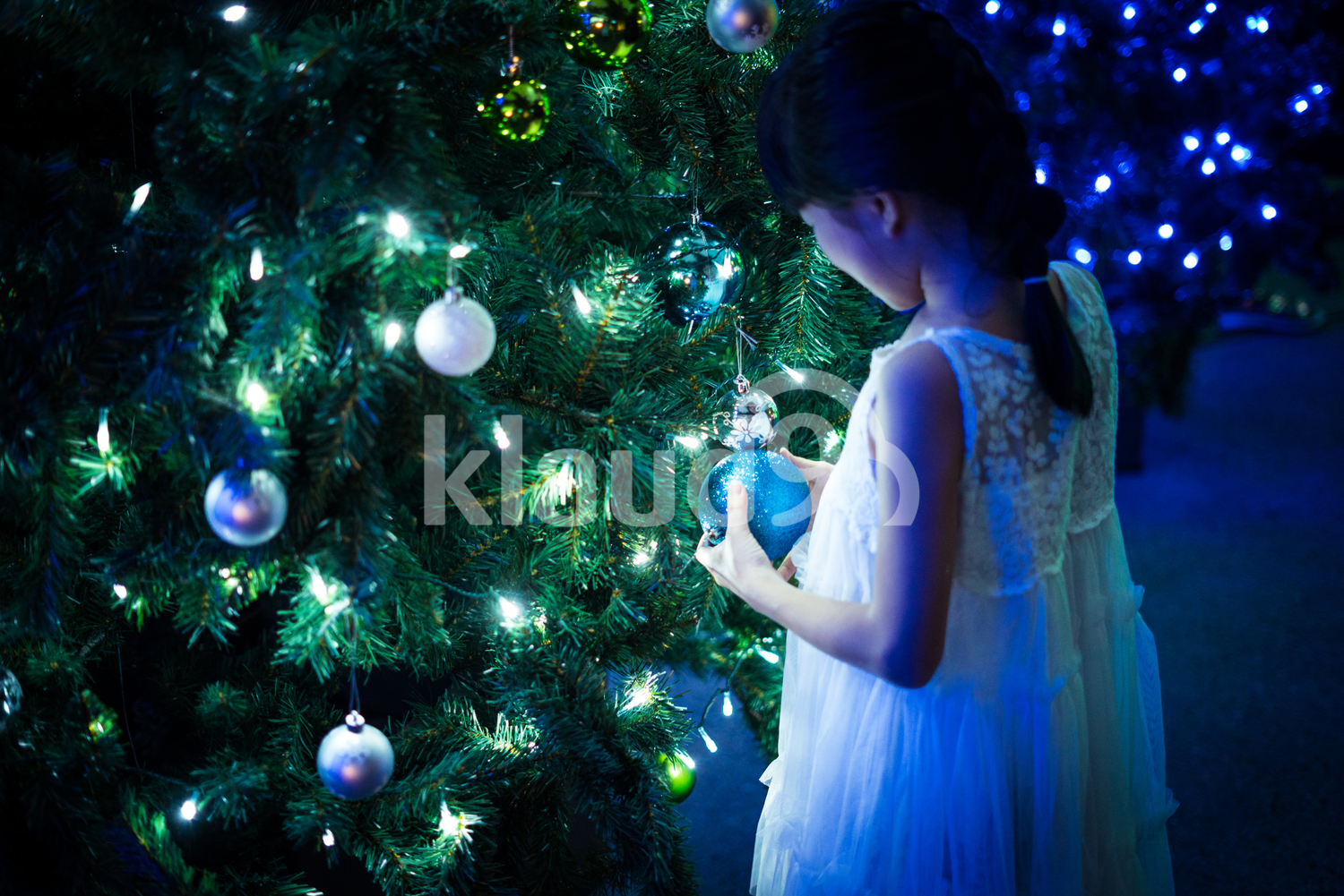 Back view of girl with Christmas tree