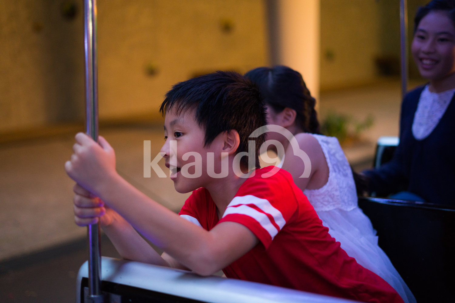Young boy riding a Christmas train