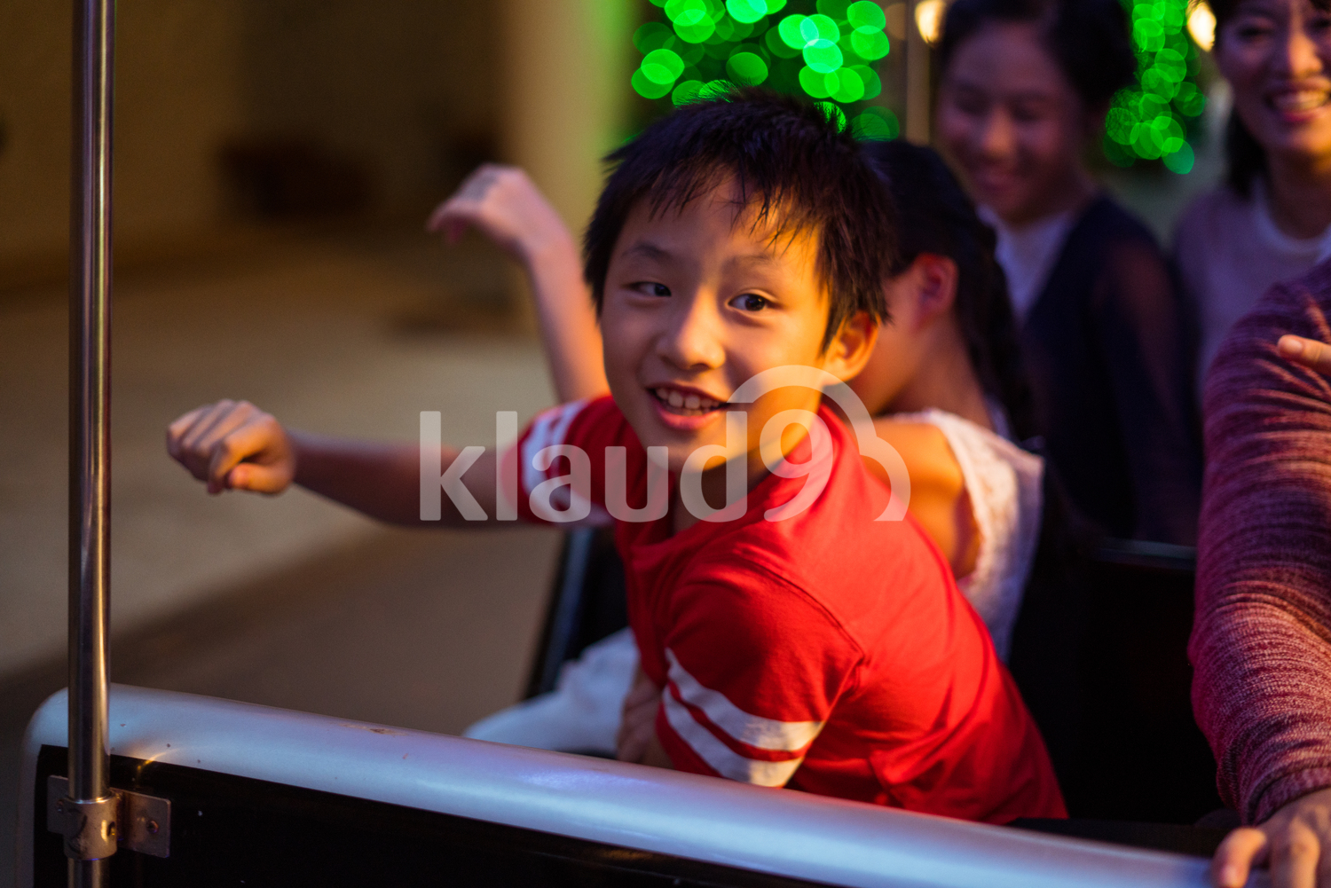 Cheeky boy riding a Christmas train