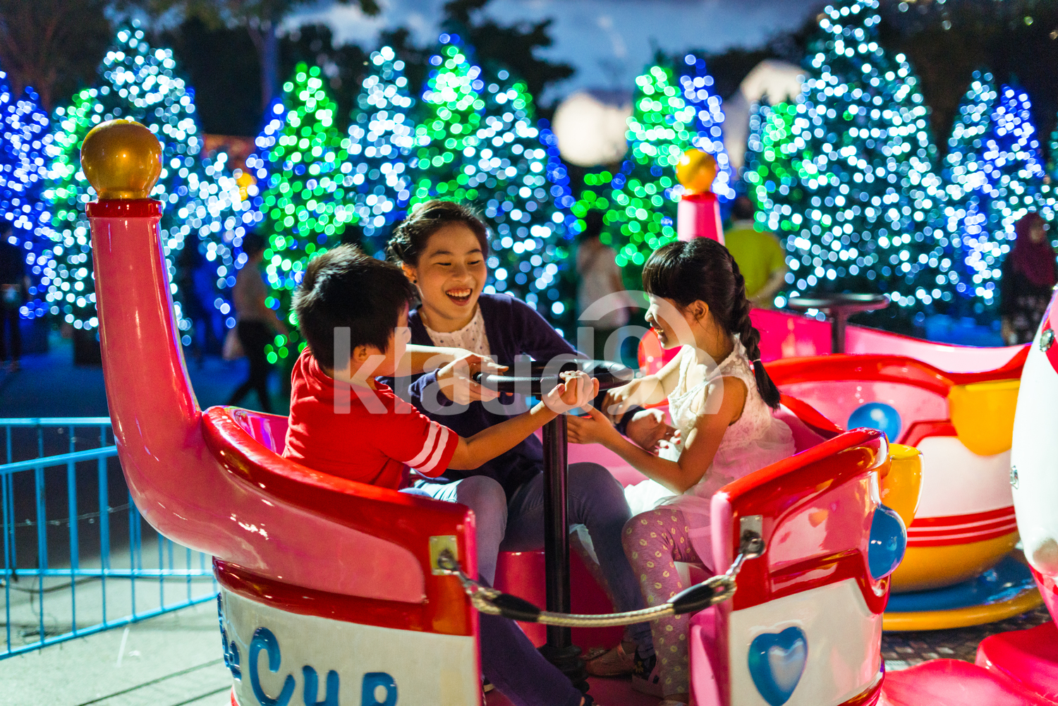 Siblings riding a Christmas train