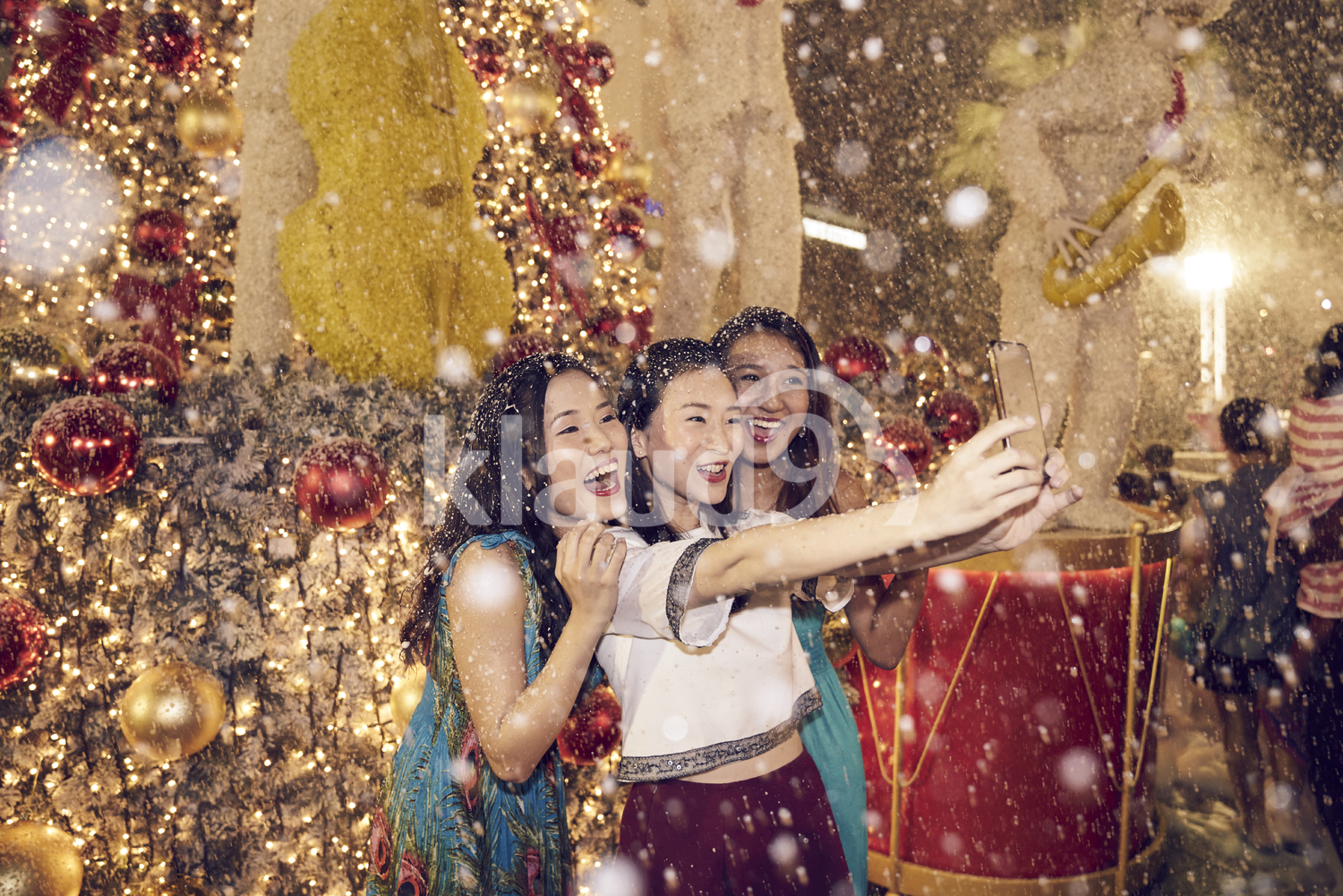Three women taking a selfie amidst foam and bubbles