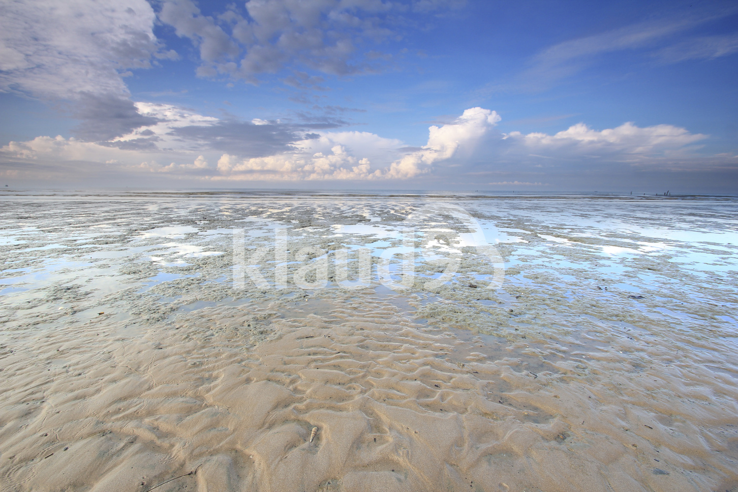 Sandy beach with beautiful clouds