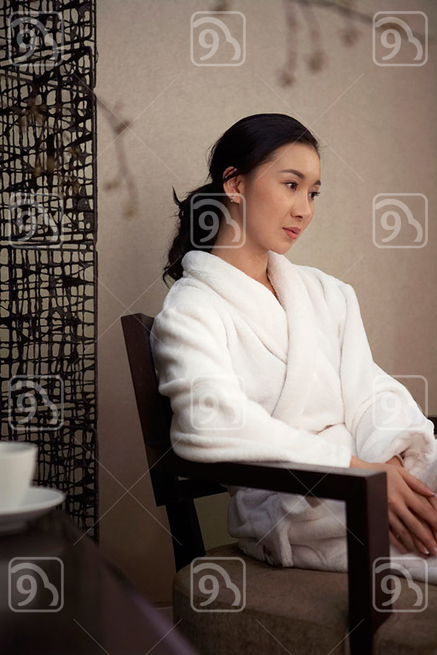 Chinese Woman Sitting In Hotel Room 