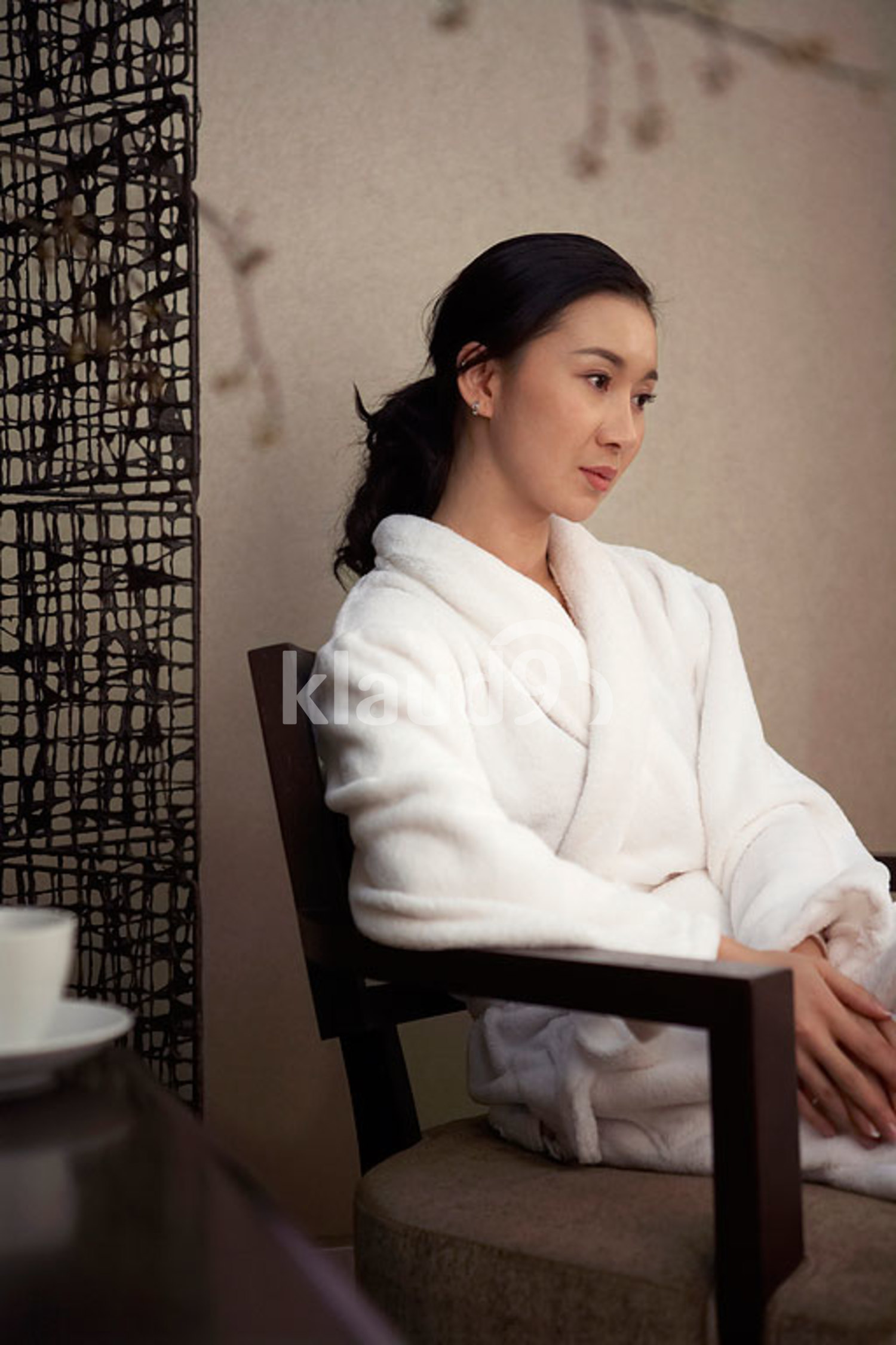 Chinese Woman Sitting In Hotel Room