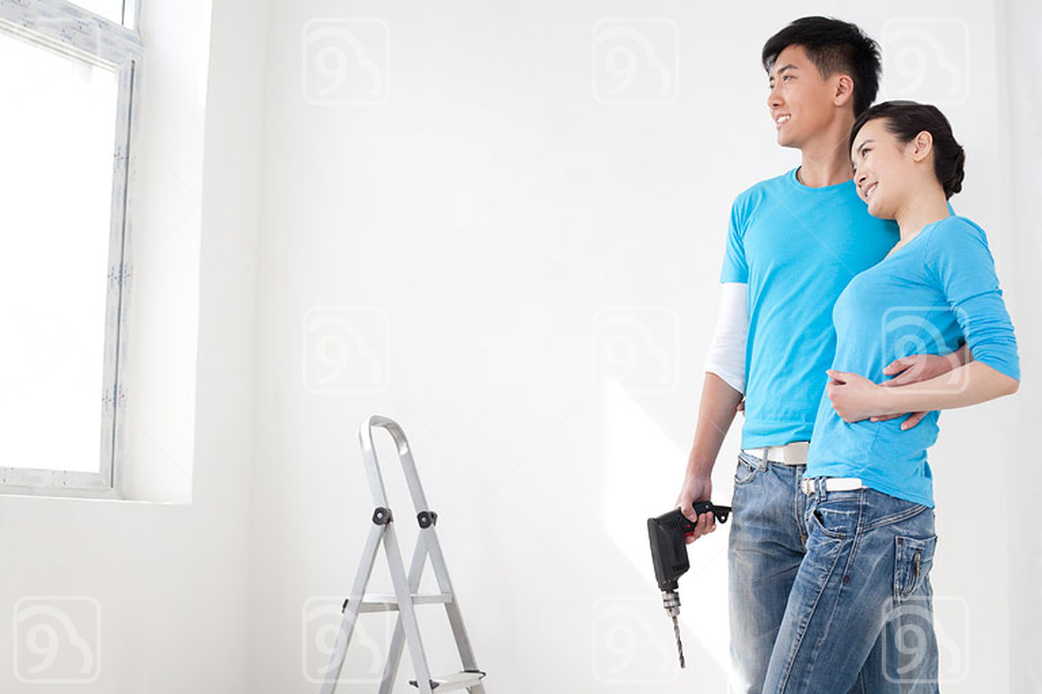 Happy Chinese couple looking out the window 