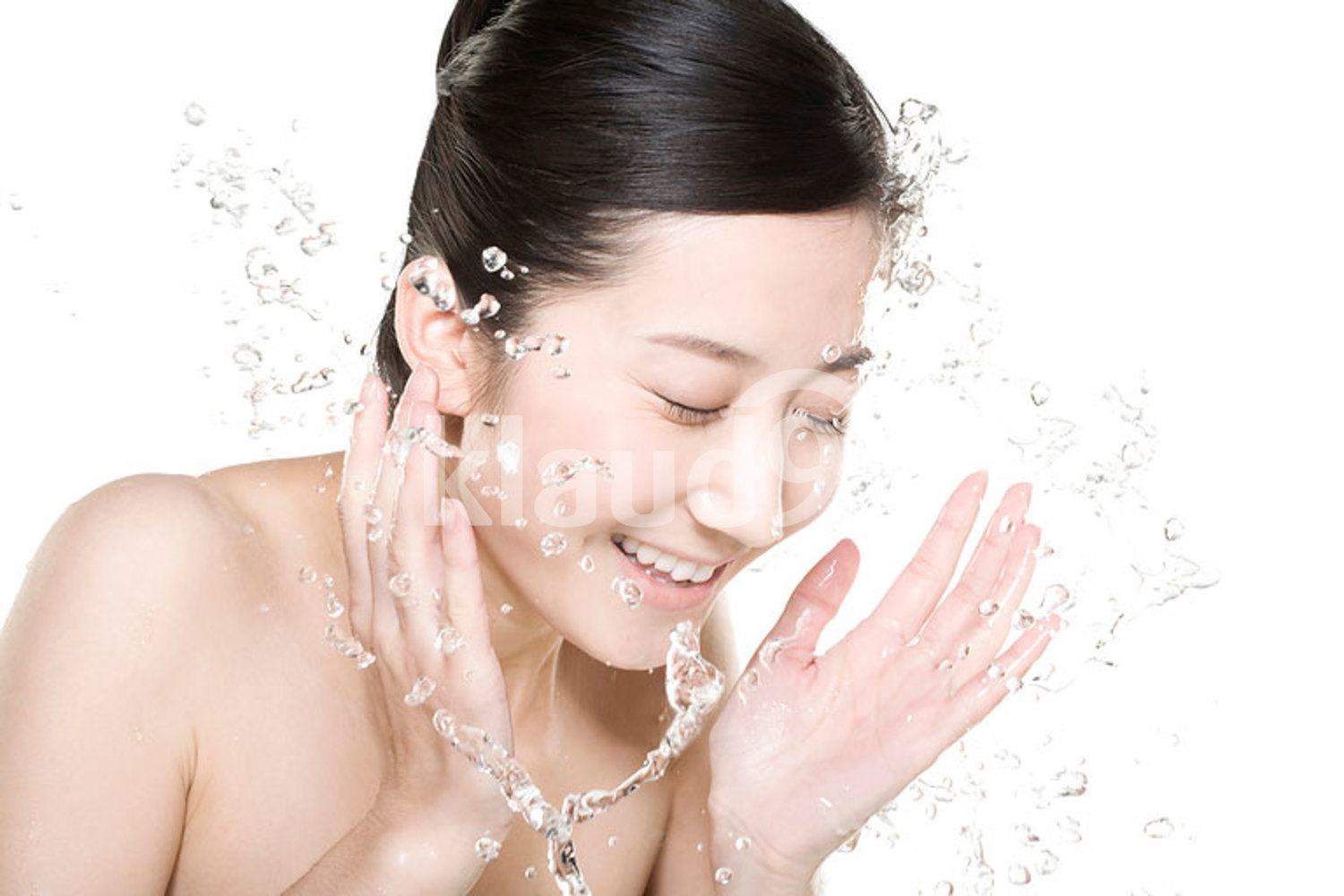 Beautiful young Chinese woman washing face