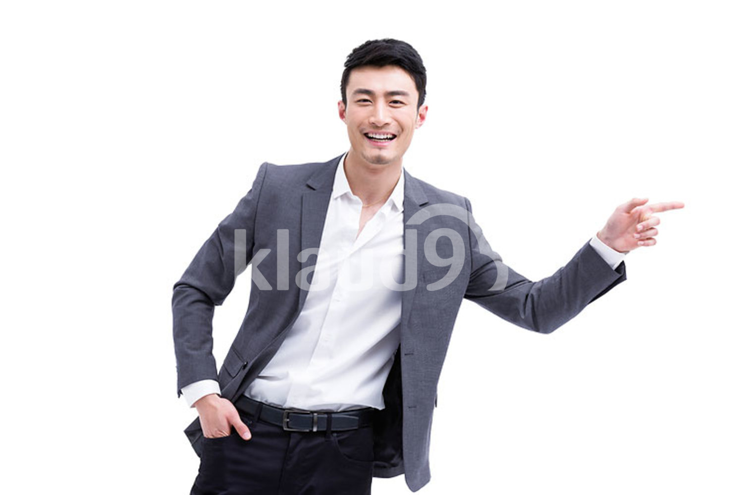 Fashionable Chinese businessman pointing away