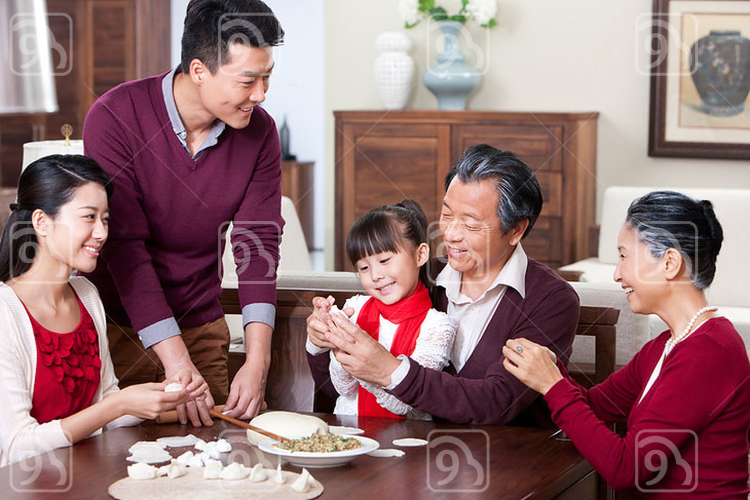 Happy family making Chinese dumplings during Chinese New Year 