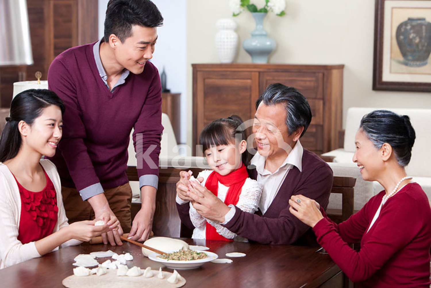 Happy family making Chinese dumplings during Chinese New Year