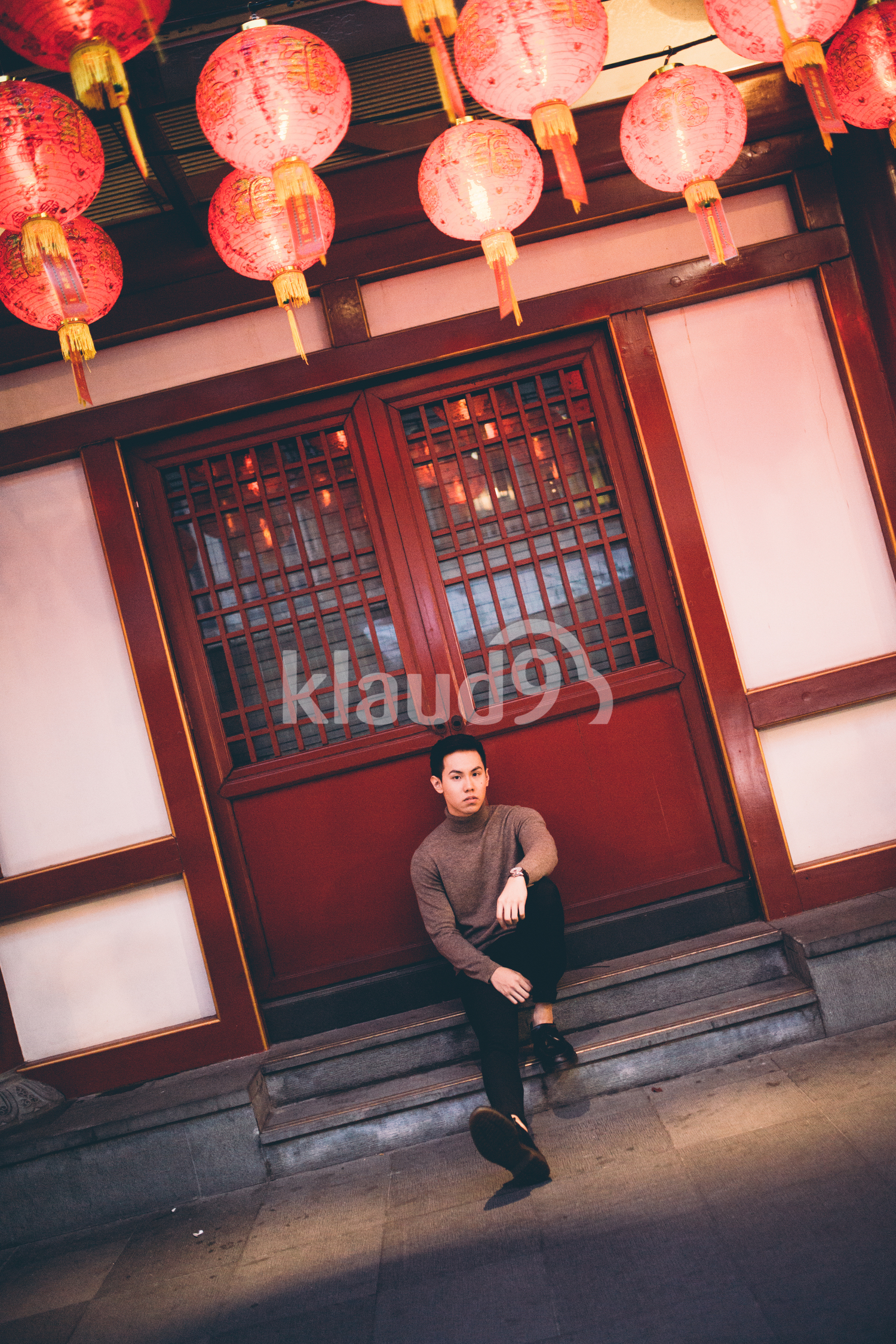 Young man resting on Temple steps in Chinatown, Singapore