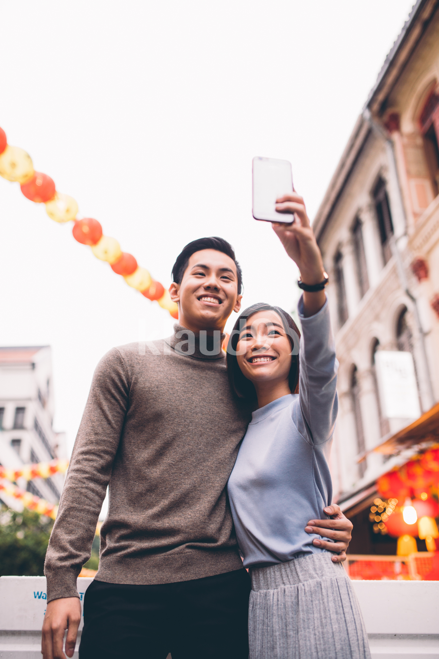 Beautiful couple doing a selfie in Chinatown, Singapore