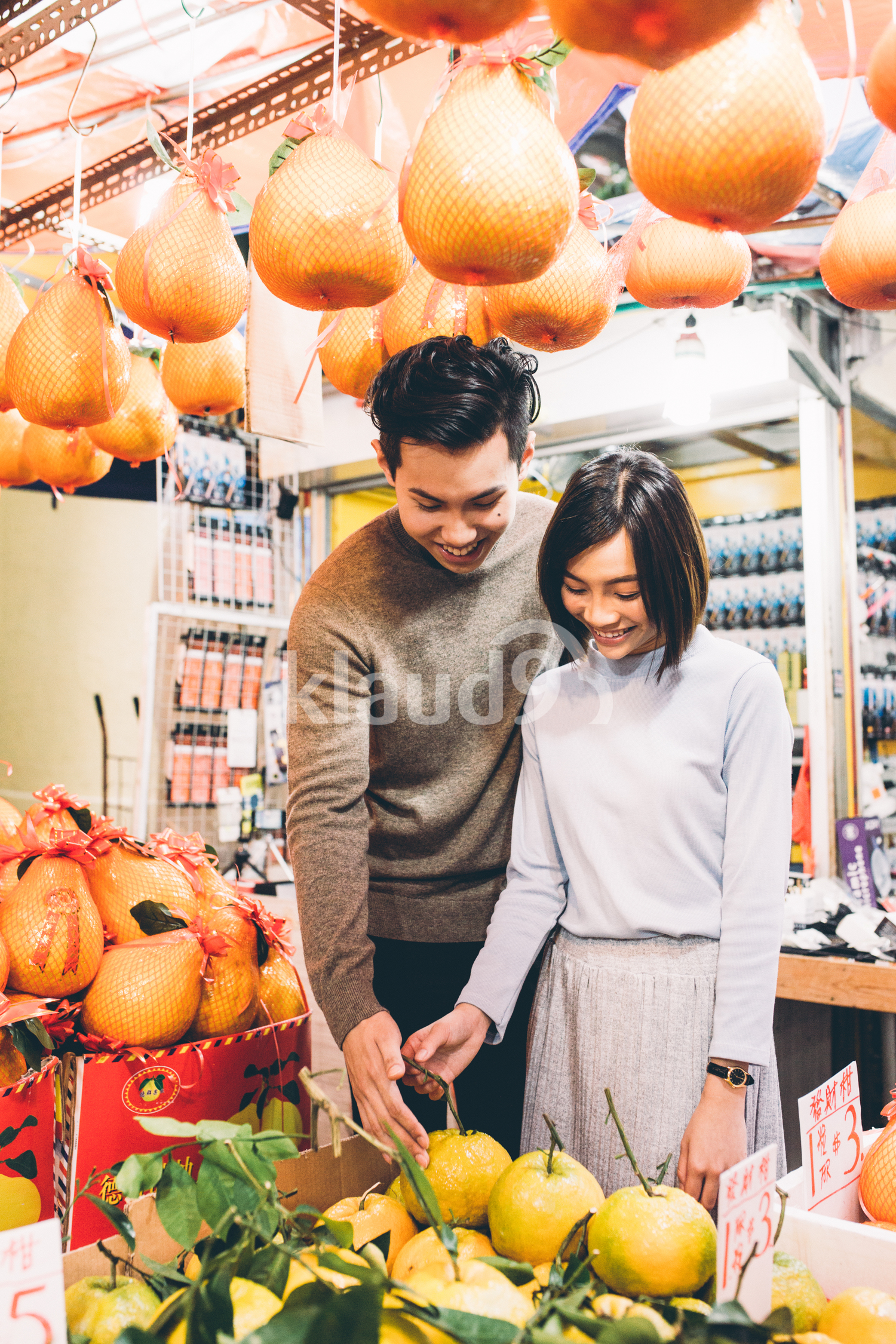 Beautiful couple buying fruits in Chinatown, Singapore