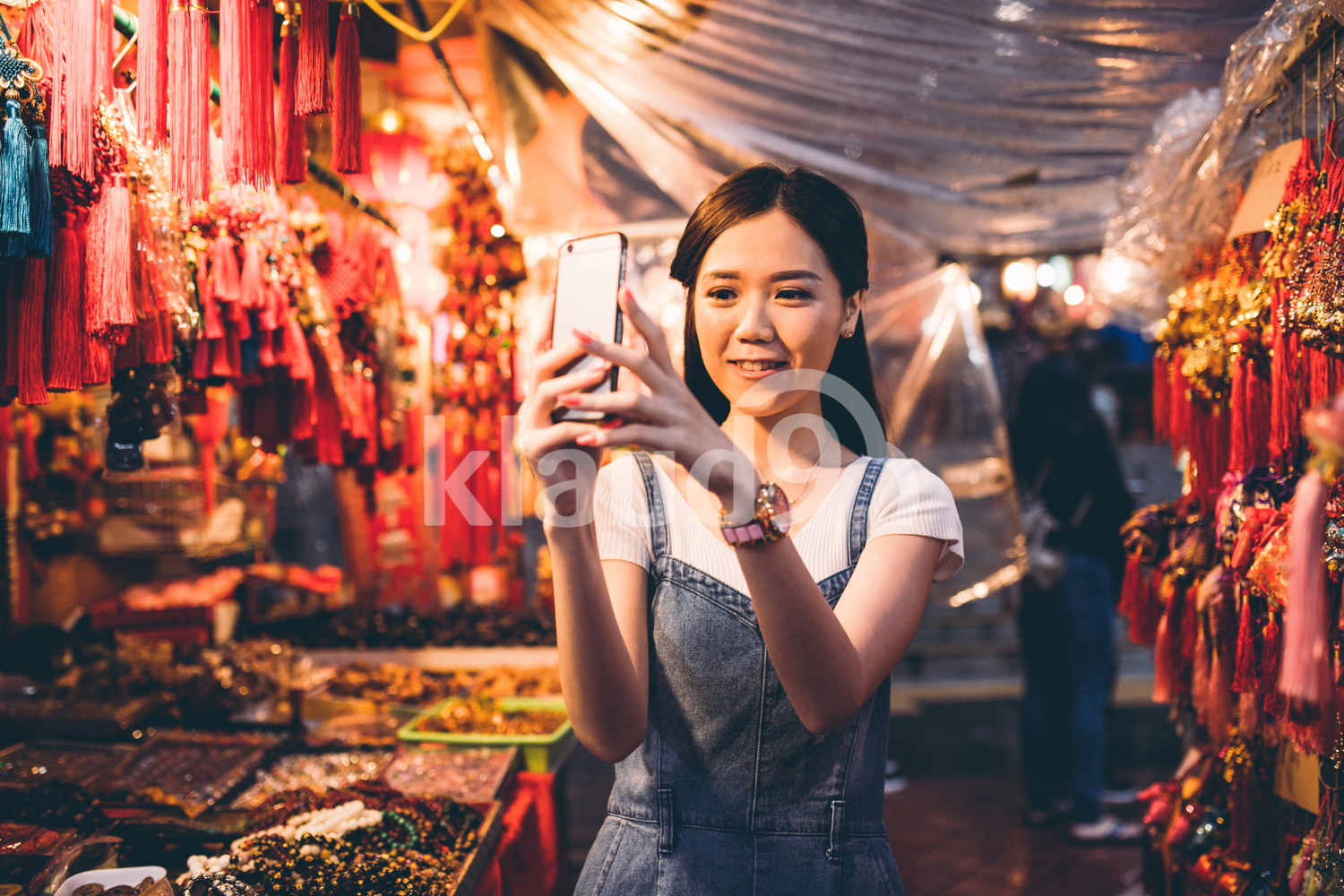 Young lady taking a photo in Chinatown, Singapore