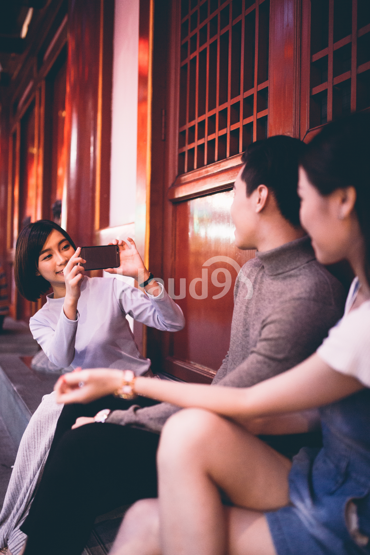 Female photographer taking a photo for her friends in Chinatown, Singapore