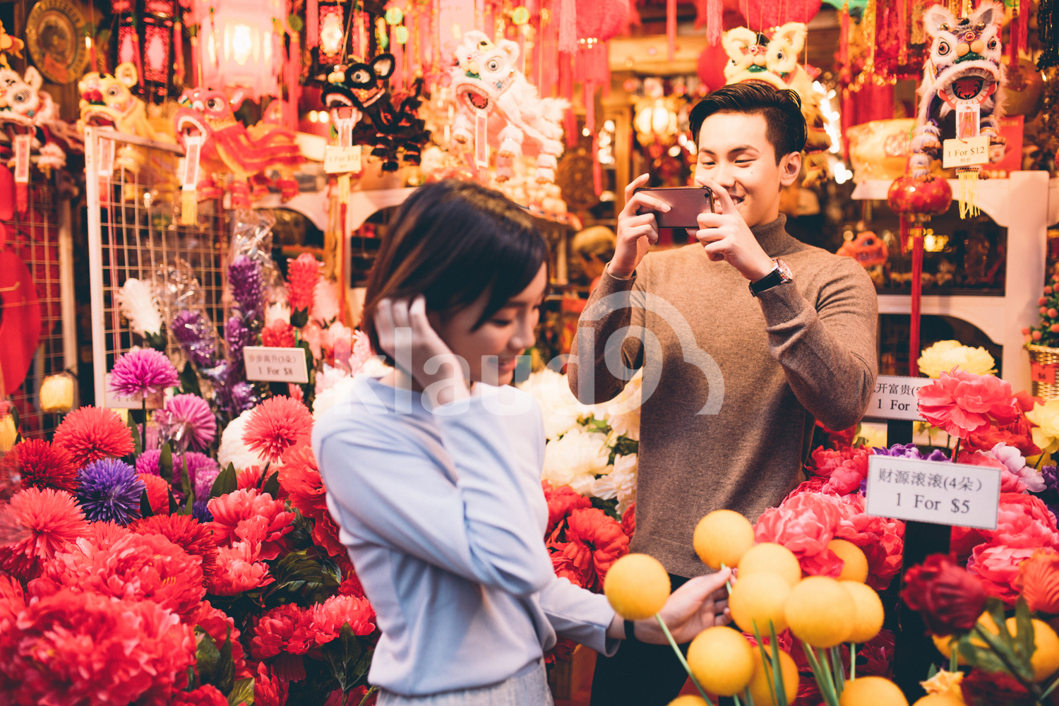 Man taking a photo of his partner shopping in Chinatown, Singapore
