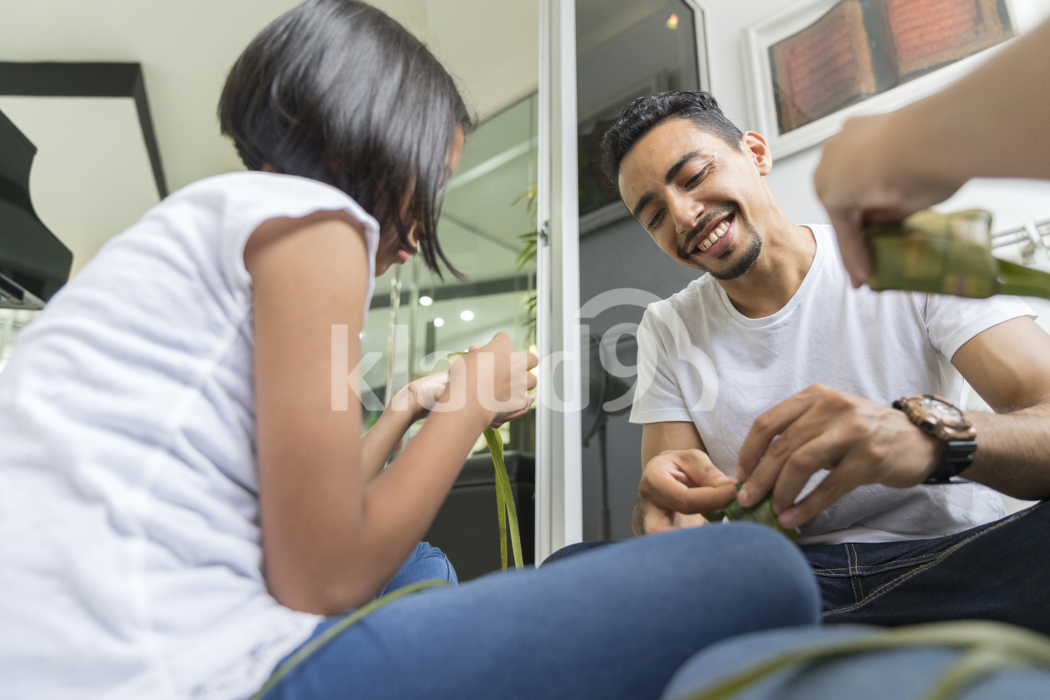 Family bonding over preparation of Ketupats