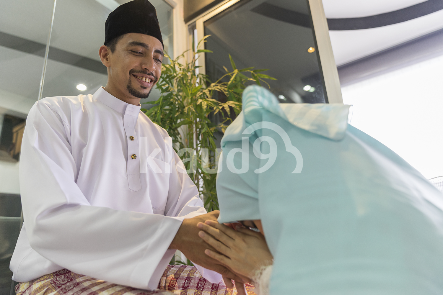 Young Wife seeking forgiveness from husband as part of the custom for Hari Raya