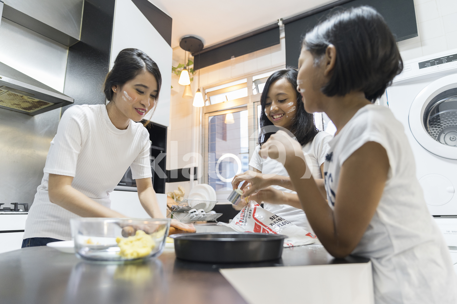 Mother and her daughters having fun during baking