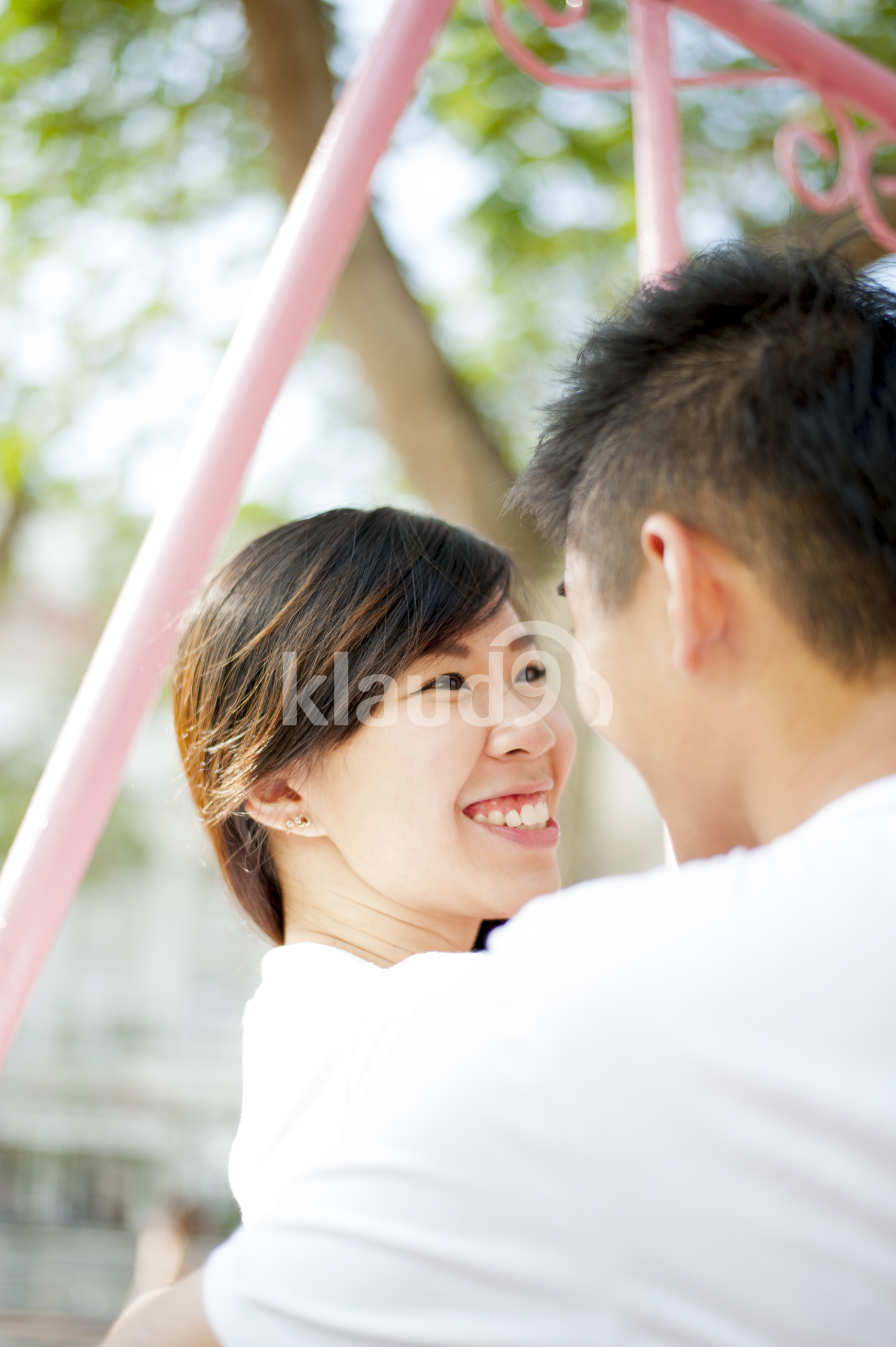 Lovely couple sitting on a swing