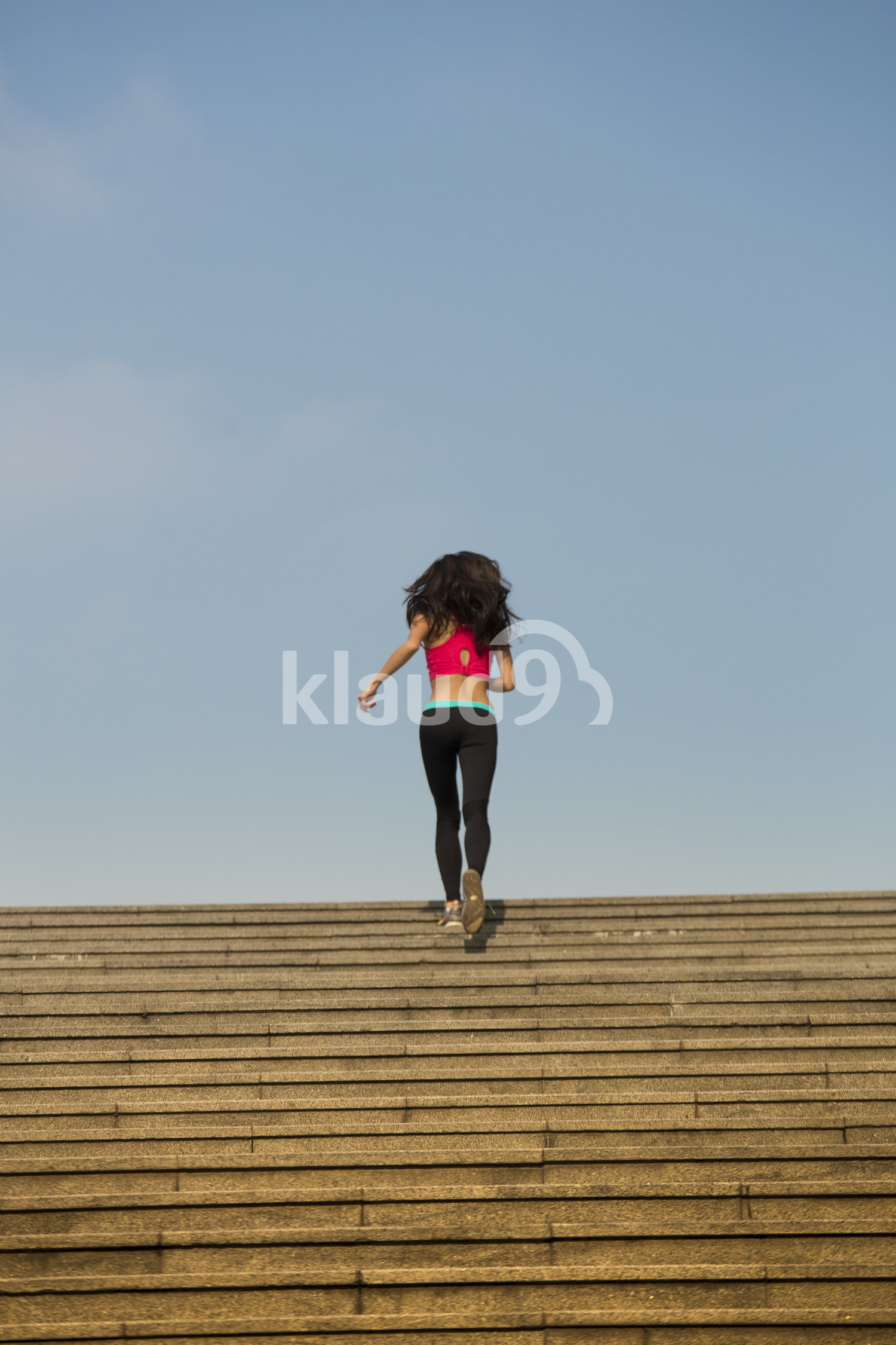 Back view of asian woman jogging 