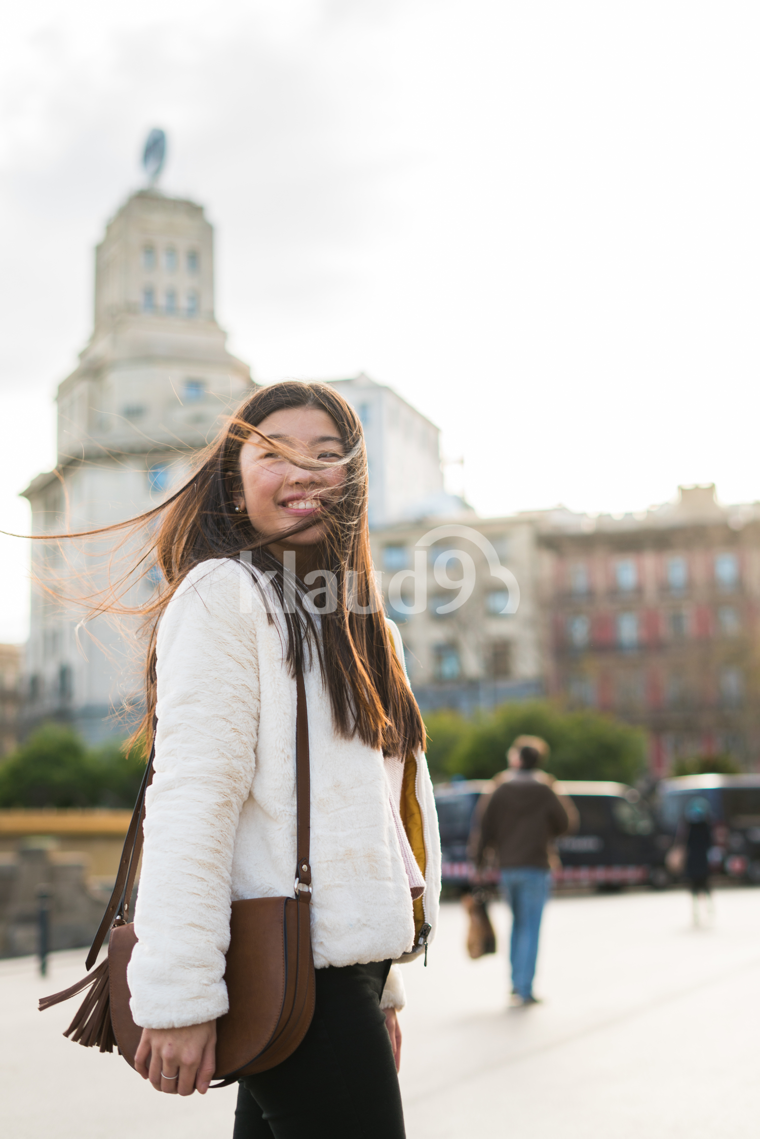 Young chinese woman on vacations exploring the streets of Barcelona, Spain on a sunny day