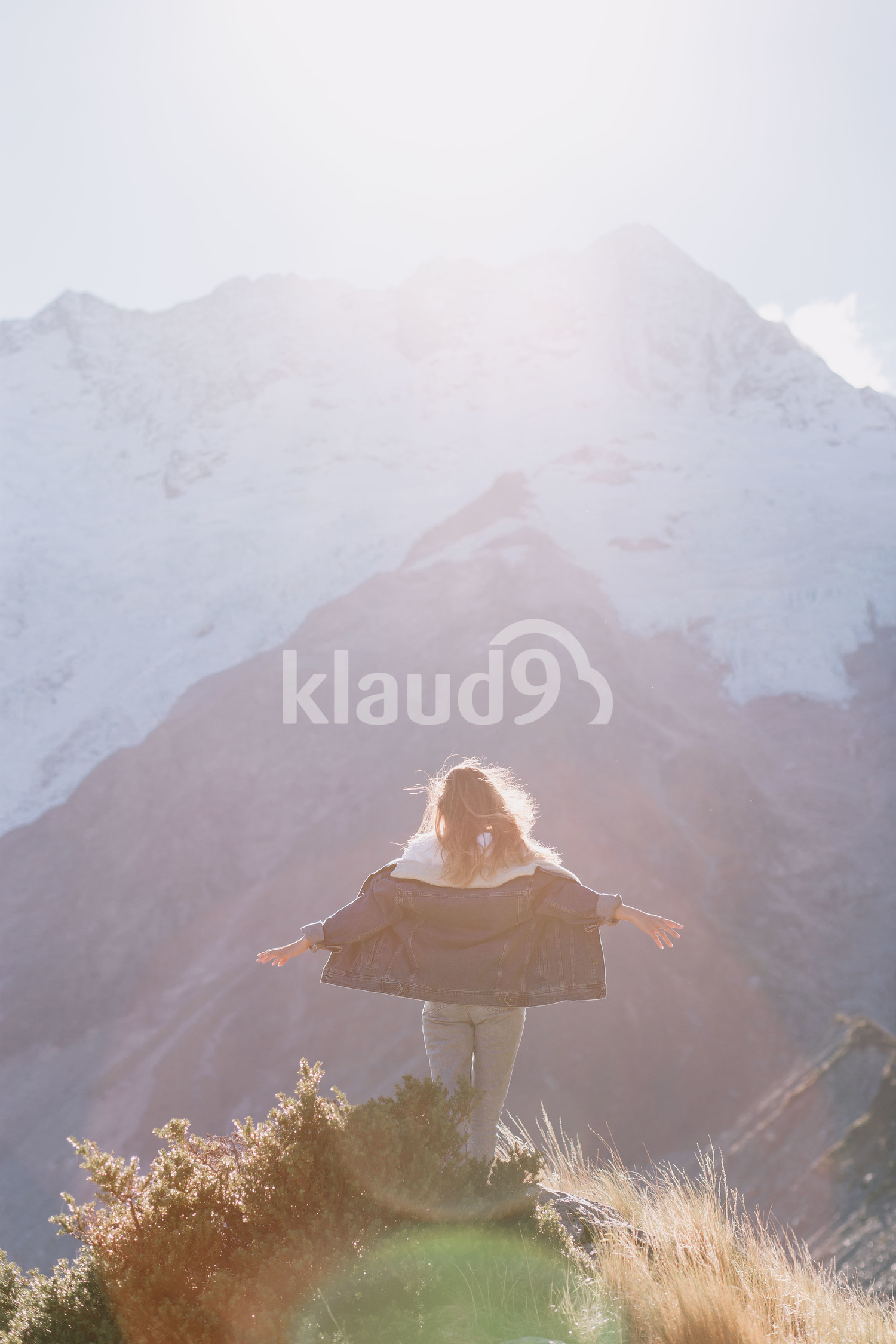 Young hipster woman climbing up Mountain Cook National Park in New Zealand