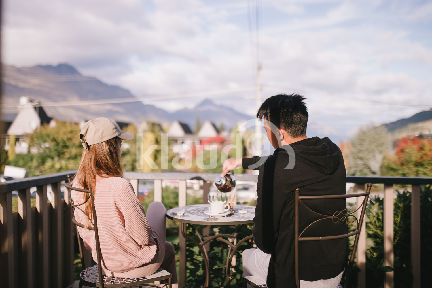 Couple chilling by the balcony at home in Queenstown, New Zealand