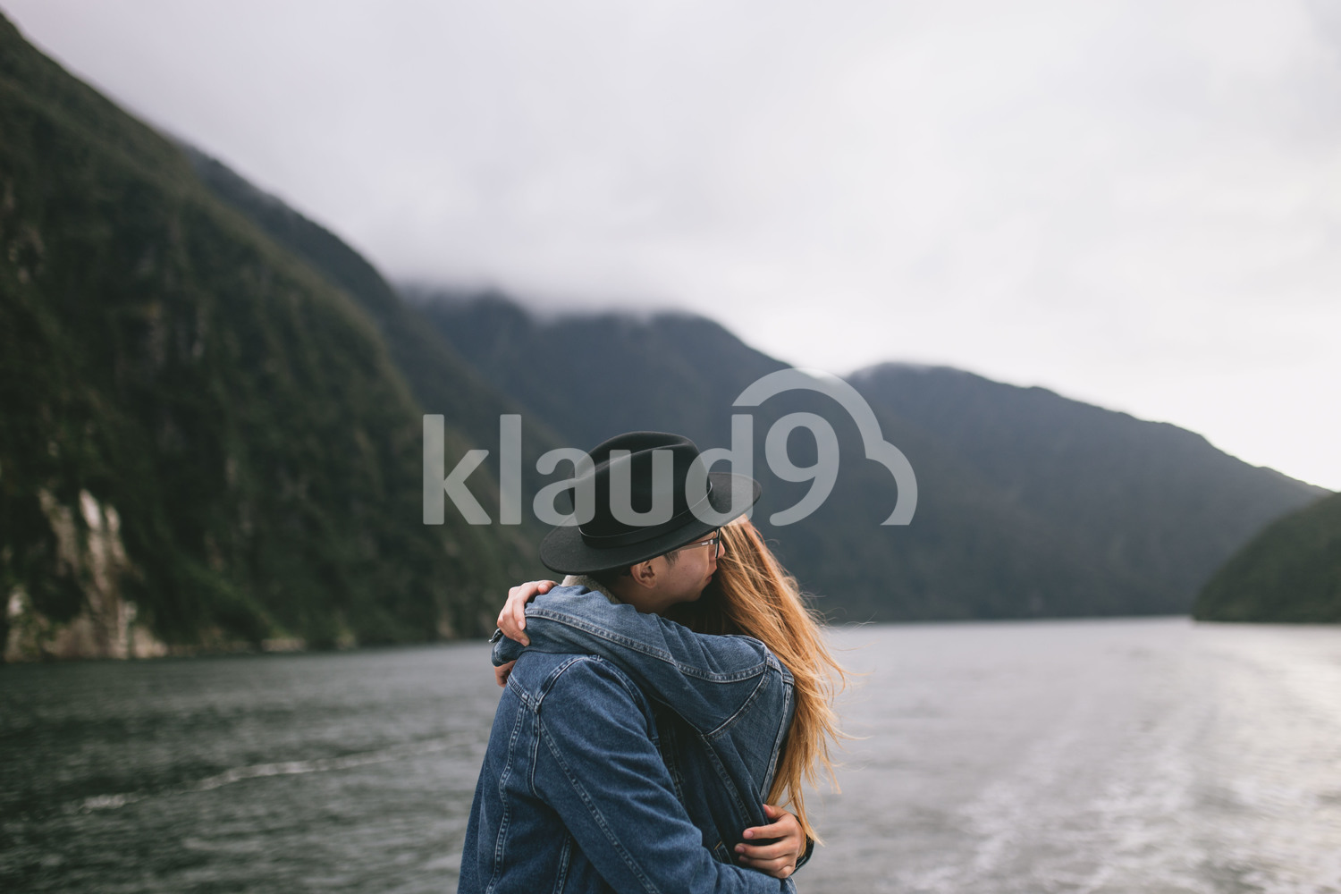 Couple hugging with the beautiful Milford Sound in the background