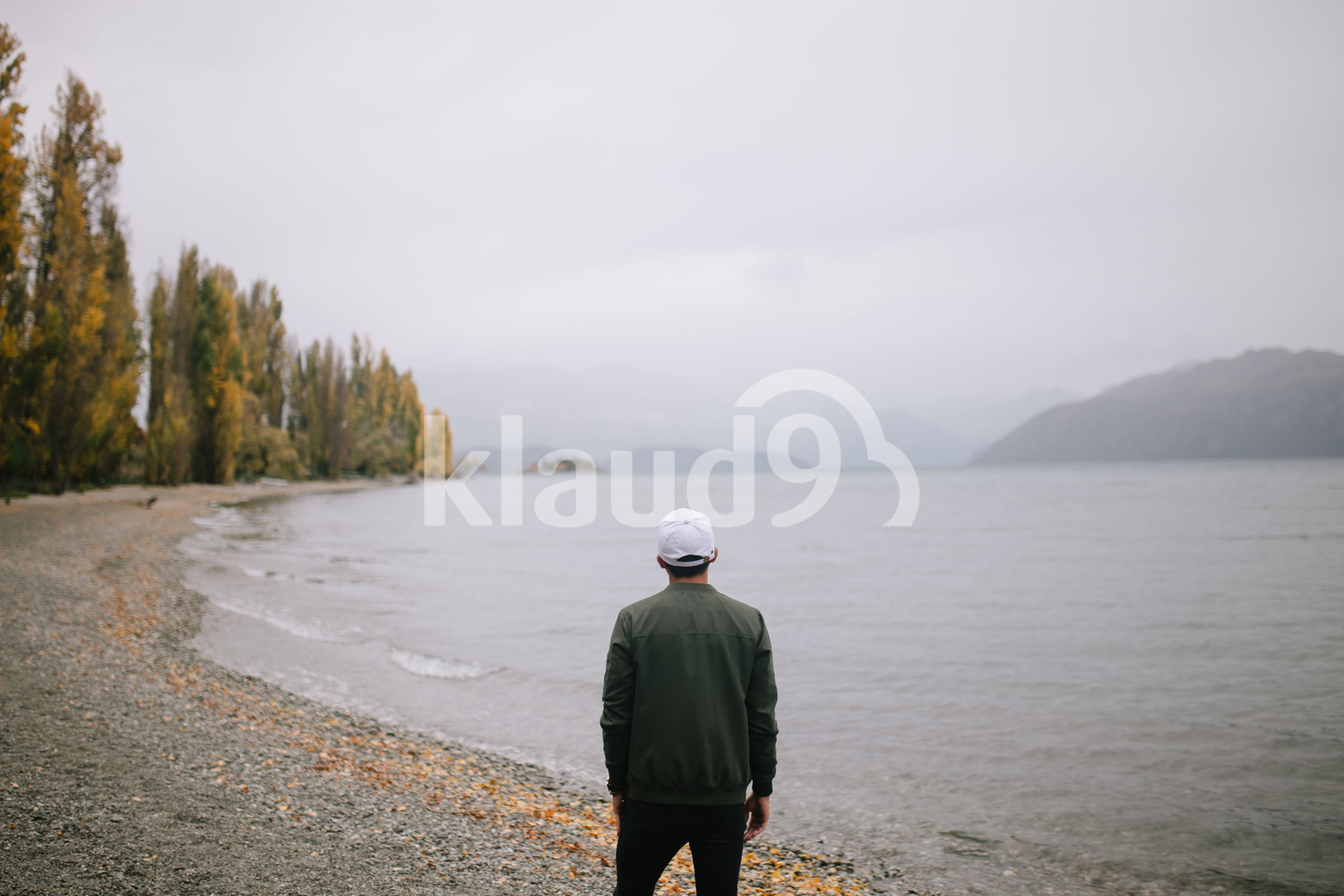 Young man exploring Milford Sound, New Zealand