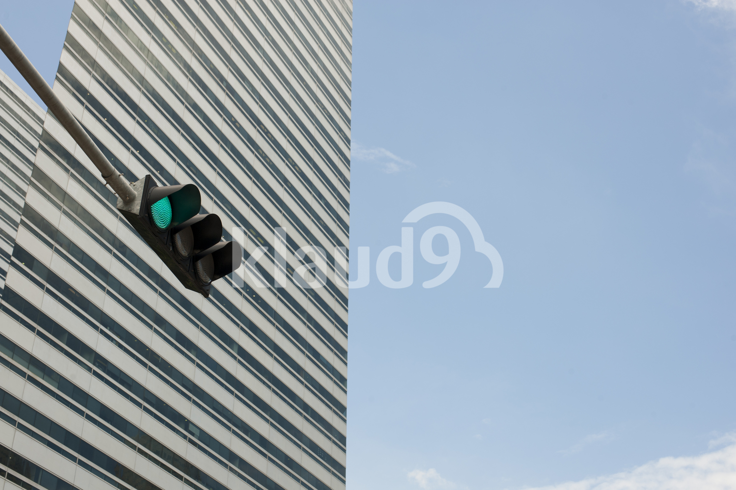 Skyscraper with traffic lights in the foreground