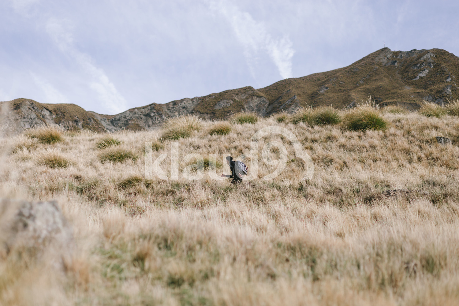 Young man running up Mountain Cook National Park in New Zealand
