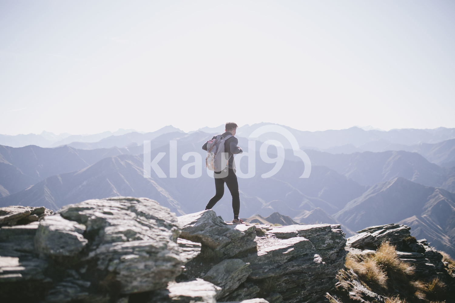 Back view of a young man trekking through Mountain Cook National Park in New Zealand