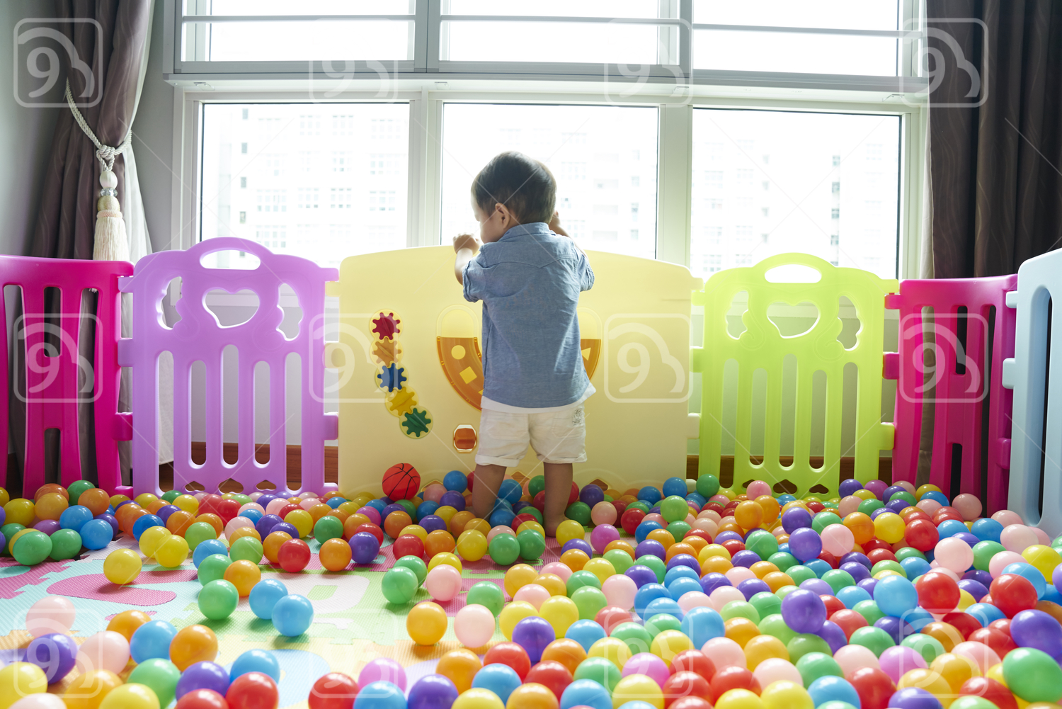 Cute Baby having fun roaming around in a play pen 