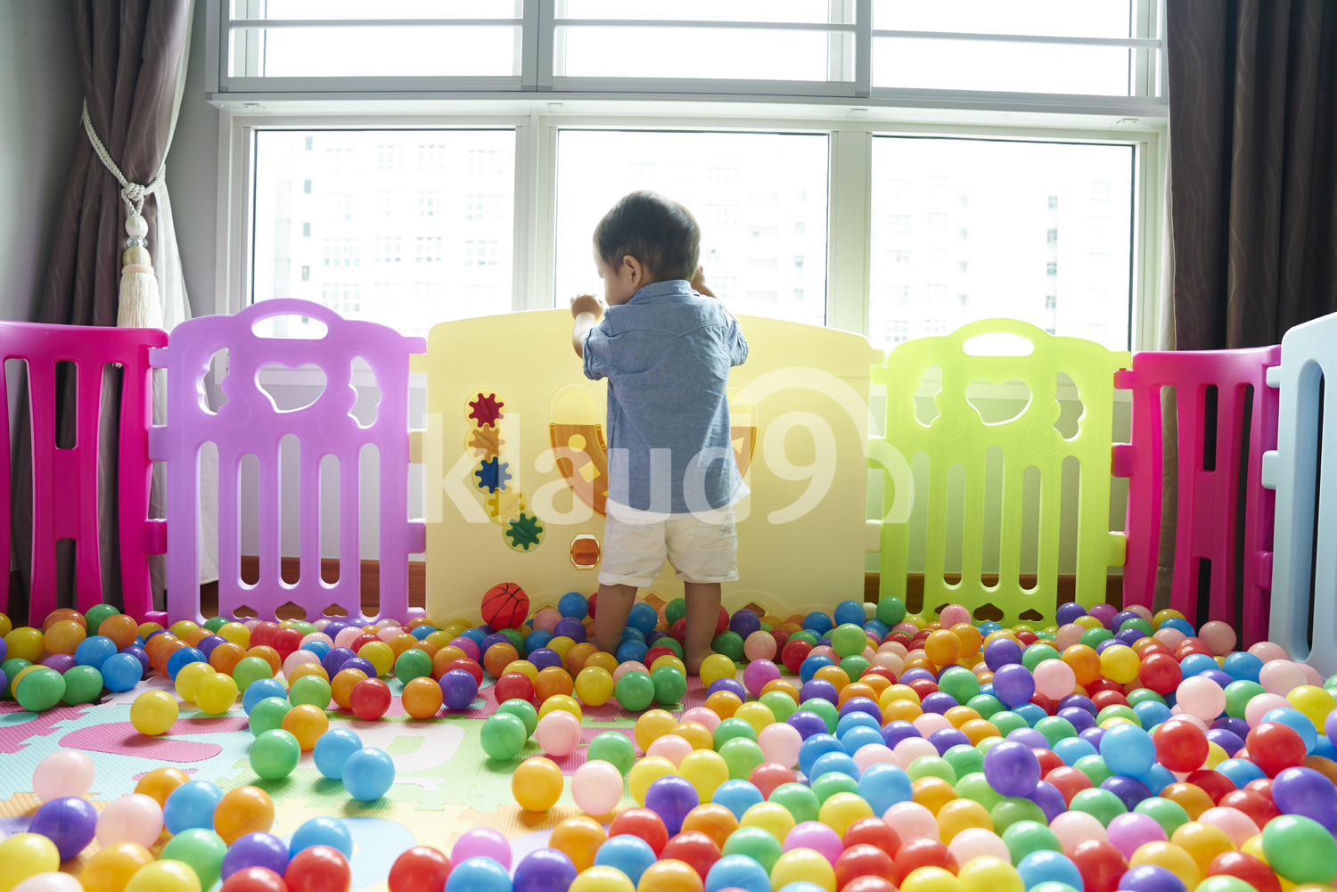 Cute Baby having fun roaming around in a play pen