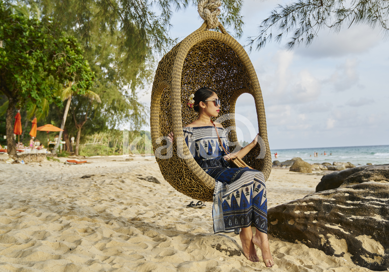 Young woman sitting by the beach in Koh Kood, Thailand 
